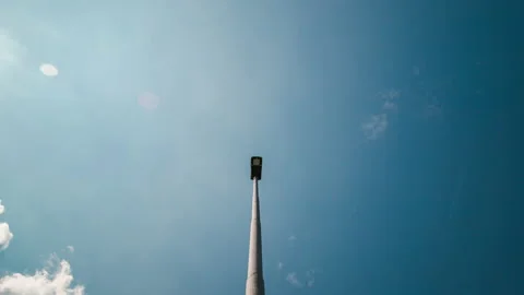 Bottom view of a blue sky with clouds over a streetlight. Timelapse 4K Stock Footage 141291752