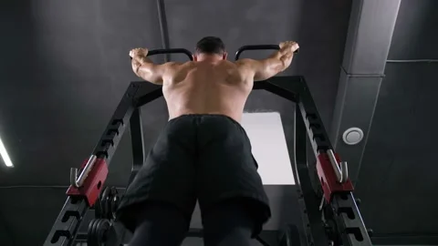 Bottom view. Bodybuilder does pull-ups on horizontal bar 4K Slow Mo Stock Footage 100258528
