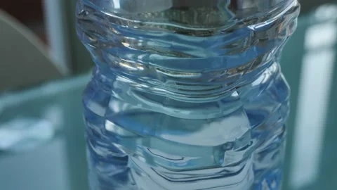 Bottom-up view of a bottle containing water placed on the kitchen table Stock Footage 143346837