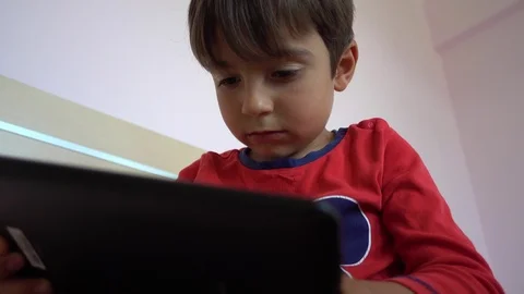 Bottom view on boy playing on tablet 2, Crystal child Stock Footage 89447119