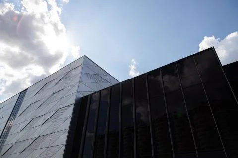 Bottom view of building with triangular pattern and round openings on wall and Fotos de archivo