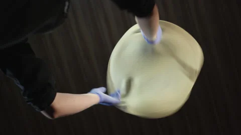 Bottom view chef in the kitchen throws pizza dough, it flies up. Stock Footage 149412046