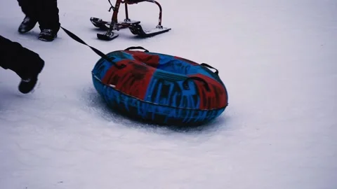 Bottom view. Children pull snow tubing, sled, winter sport, activity Stock Footage 211626342