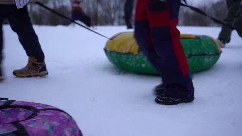 Bottom view. Children pull snow tubing, sled, winter sport, activity 스톡 동영상 219995064