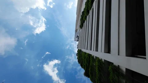 Bottom view of clear sky and a shopping mall building from a moving car Stock Footage 234886289