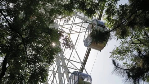 Bottom view close-up ferris wheel slowly spins in circle Stock Footage 90632252
