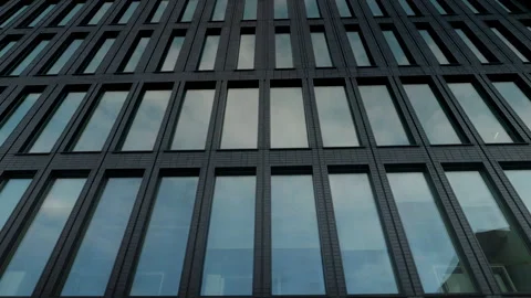 Bottom view on clouds reflected at large glass windows of modern office building Stock Footage 273165364