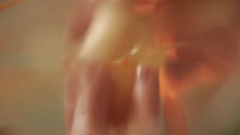 Bottom view of cracking a raw chicken egg into clear bowl, macro shot Stock Footage 346878047