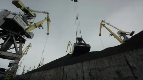Bottom view of cranes working with coal against blue sky. Transport hub, daily Stock Footage 205234340