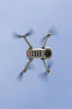 Bottom view of a drone flying with the light blue sky on the background Stock Photos