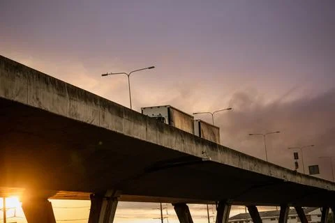 Bottom view of elevated concrete highway with truck driving. Overpass concr.. Foto stock