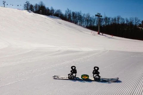 Bottom view on empty ski slope and equipment for snowboarding Stock Photos