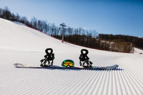 Bottom view on empty ski slope and equipment for snowboarding Stock Photos