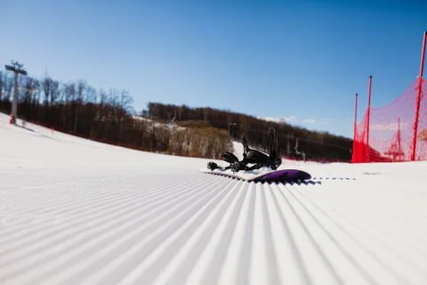 Bottom view on empty ski slope and equipment for snowboarding Stock Photos
