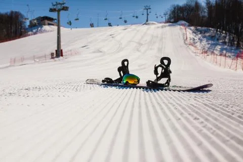 Bottom view on empty ski slope and equipment for snowboarding Stock Photos