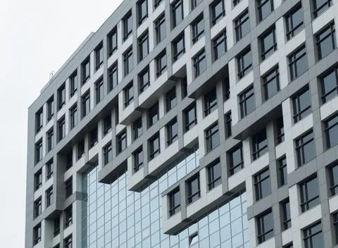 Bottom view of the facade of a modern building with many glass windows Stock-Fotos