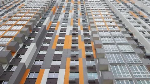Bottom view of the facade of a new multi-storey residential building with bal Stock Photos