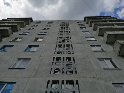 Bottom view of the facade of an old Soviet socialist panel house. Stock Photos