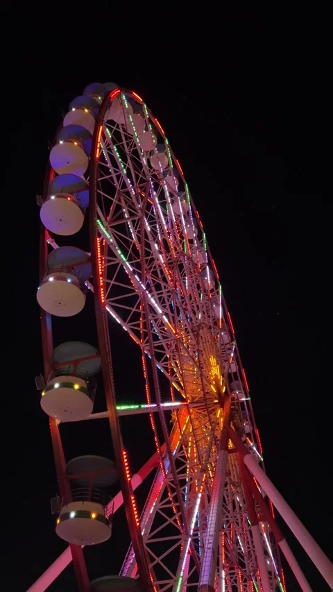 Bottom view of the Ferris wheel. Multicolored lights Stock Footage 252459869