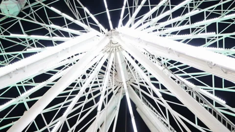 Bottom view of Ferris wheel spinning and flashing white lights at night Stock Footage 137806290