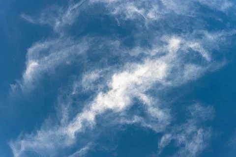 Bottom view of fluffy white cloud on deep blue sky Stock Photos