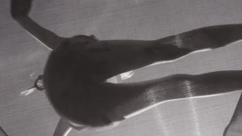 Bottom up view on girl bouncing on a trampoline. Slow motion full HD video child Stock Footage 247004158