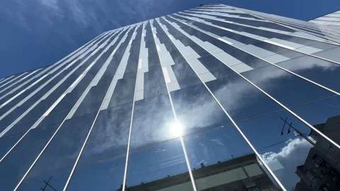 Bottom up view of the glassed office building exterior with sunny sky reflection Stock Footage 209394996
