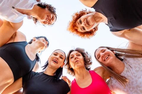 Bottom view of group of multiethnic happy fit women in sportswear and look .. Stock Photos