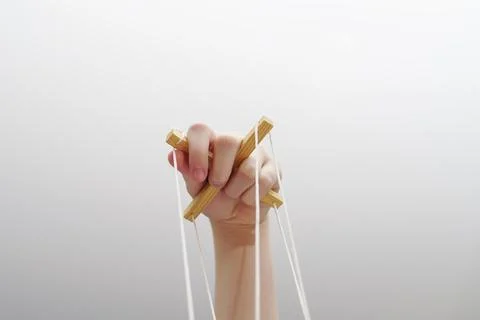 Bottom view of hand with cross for puppet and control thread Stock Photos