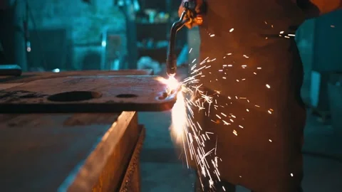 Bottom view of the hands of a worker cutting metal with an oxy-fuel torch. Stock Footage 228947713