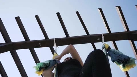 Bottom up view of hanging hammock for hatha yoga and woman practicing on it Stock-Footage 146552162