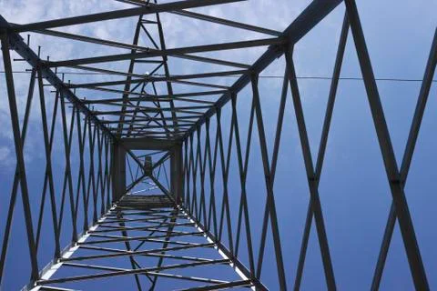 Bottom view of high voltage pole power transmission tower with sky blue day b Stock Photos