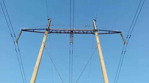 Bottom view of high voltage poles against a blue sky. Electricity Stock Footage 150703300