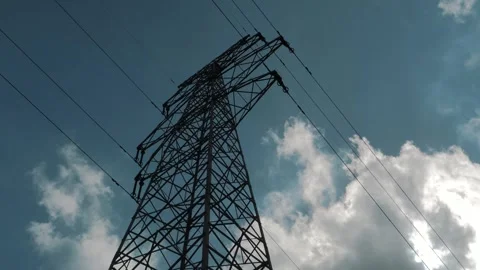 Bottom view of a high voltage power pylons against blue sky and clouds Stock Footage 251804149