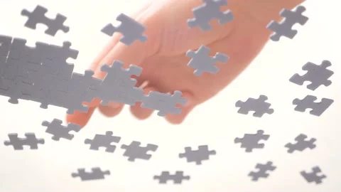 Bottom View. Human Hands Assembling Jigsaw Puzzle. Pastime, a hobby. Complex Stock Footage 143027794