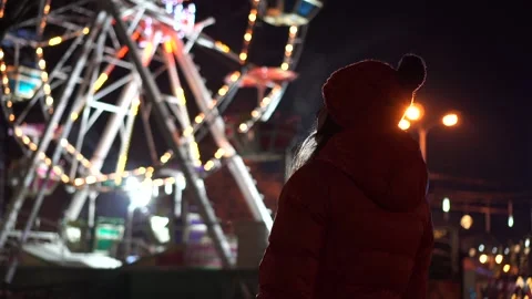 Bottom view of Illuminated Ferris Wheel with a silhouette of a girl. Winter mood Stock Footage 146283879