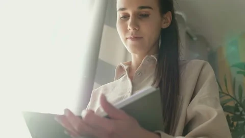 Bottom view an inspired young student girl keeps her personal diary Stock Footage 110703763