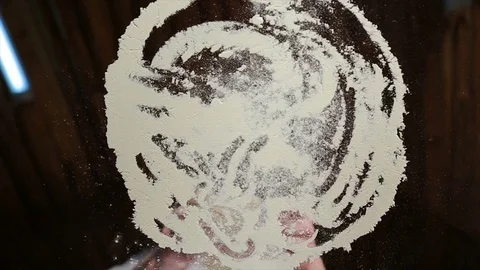 Bottom view, interesting perspective of kneading the dough in flour rolled into Stock Footage 72984112