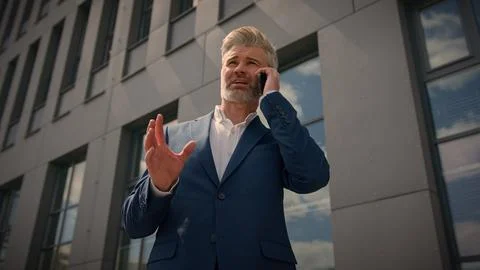 Bottom view investor developer talk cellphone city building background middle Foto stock