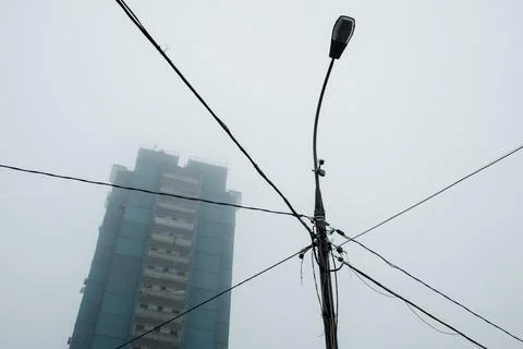 Bottom-up view of the lantern and the panel house in the fog Stock Photos
