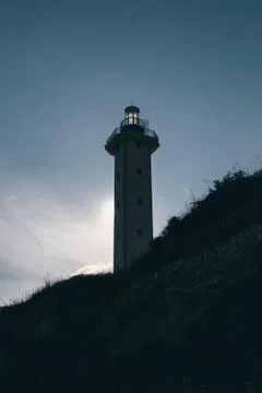Bottom view of a lighthouse hiding the sun Stock Photos