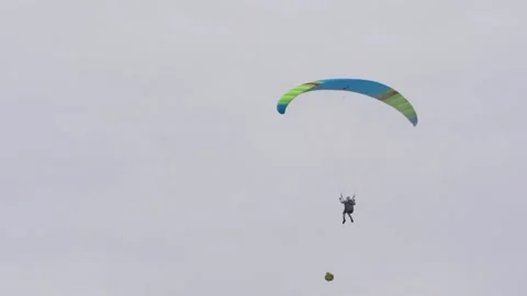 Bottom view of man with parachute in sky. Action. Person flies in sky on Stock Footage 143922336
