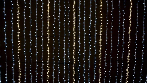 Bottom view of many small light bulbs, festive garland illuminating night sky Stock Footage 123310660
