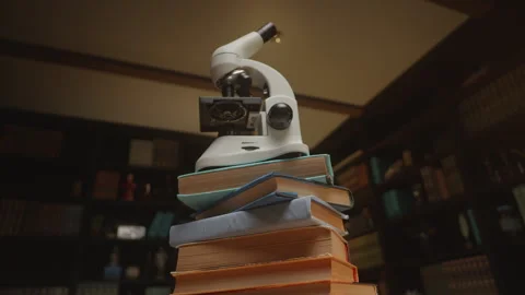 Bottom view on a microscope at the library on a stack of books, HQ 4K footage Stock Footage 273569274