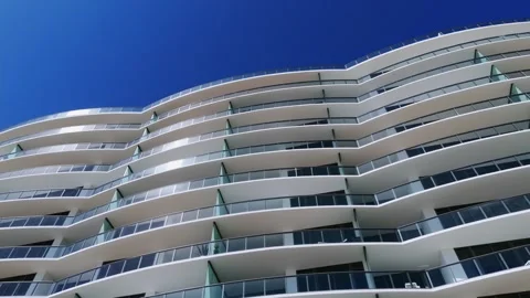 Bottom view of modern architectural building with curved balconies and clear Video stock 274393852