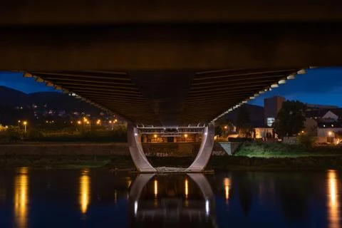 Bottom view to modern bridge wit reflection in the river at night 스톡 사진