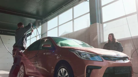 Bottom view of a modern car washing process in an indoor car wash. 4K. Video stock 231801967