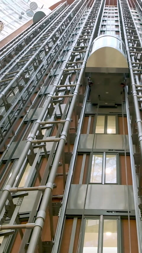 Bottom-up view of a modern elevator in an office or business center. Cinematic Stock Footage 306847952