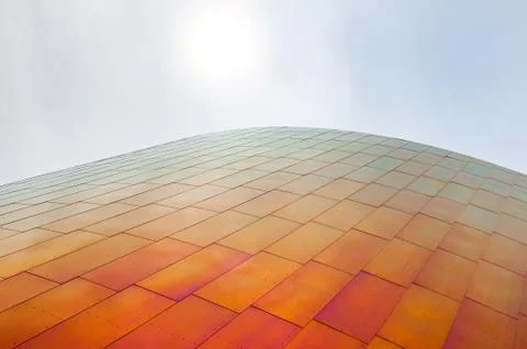 Bottom view of a modern facade and cloudy sky on the background Stock Photos
