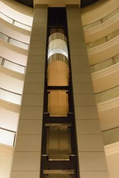 Bottom view of a modern glass elevator inside a modern building Foto stock